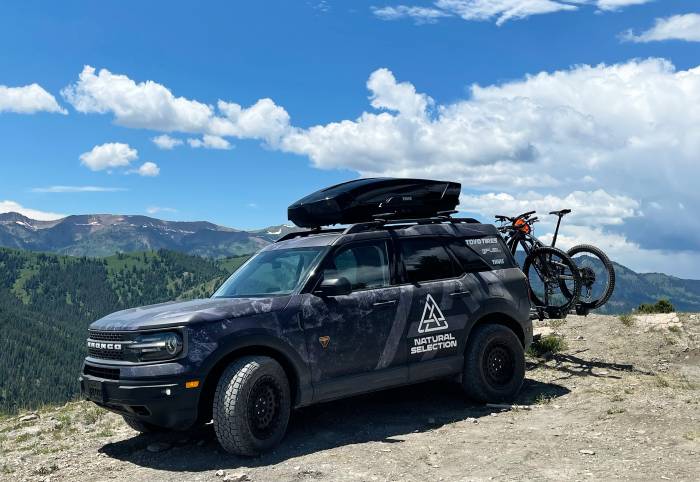 Travis Rice Natural Selection 2021 Ford Bronco parked on mountain