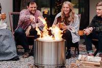 People sitting around solo stove fire pit