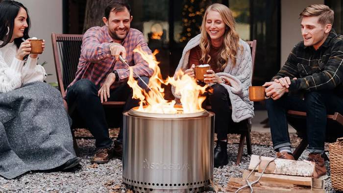 People sitting around solo stove fire pit
