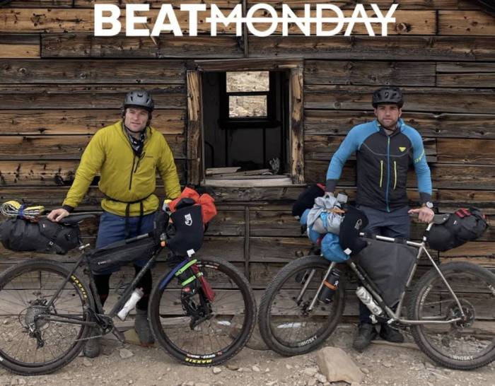 two guys and their bikes in front of an abandoned cabin on shoot for the "beat Monday" tv series