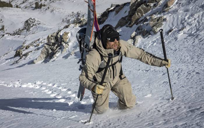 cody townsend hiking uphill through lots of snow with skis in A-frame on pack