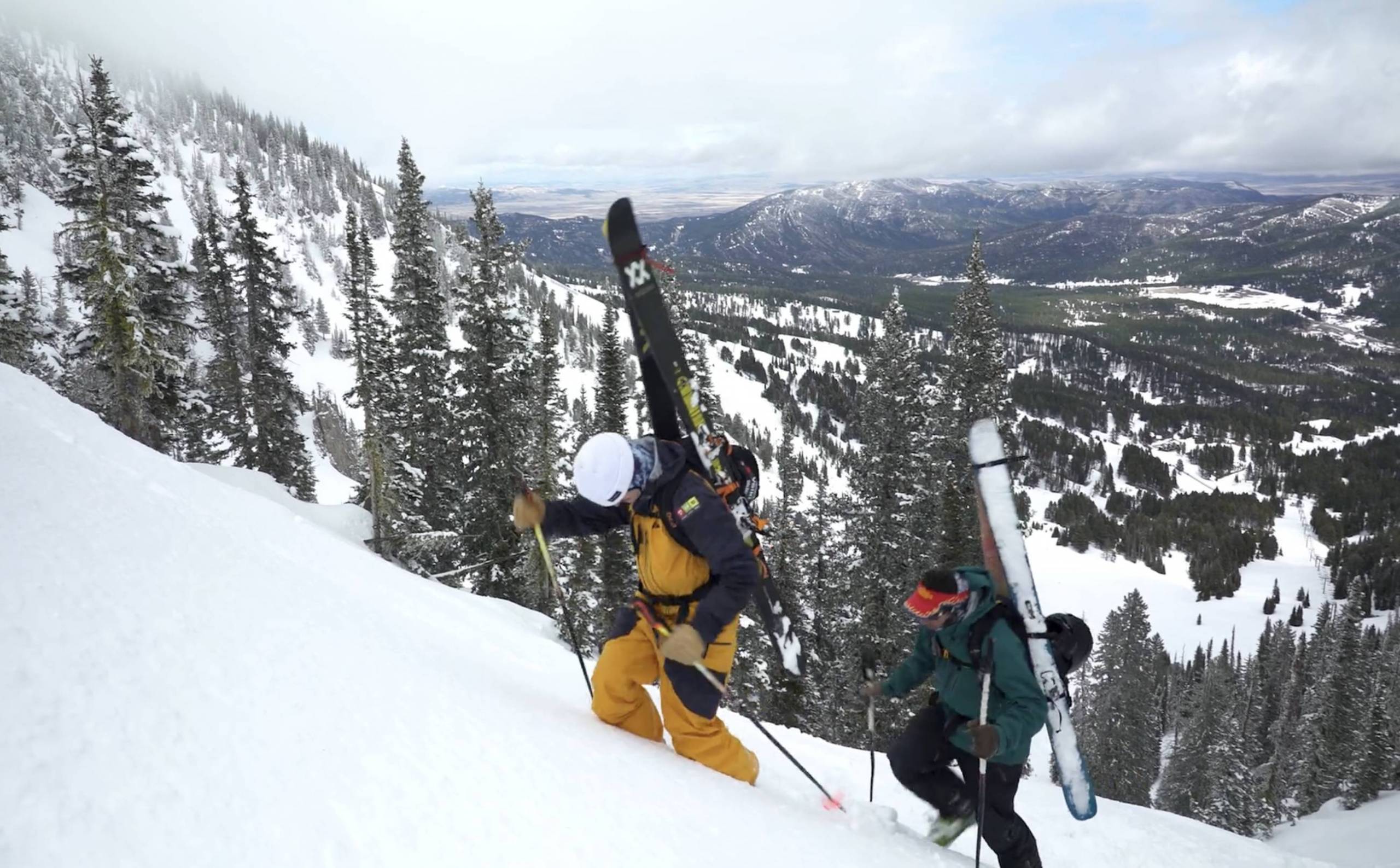 two skiers ascending mount blackmore in montana