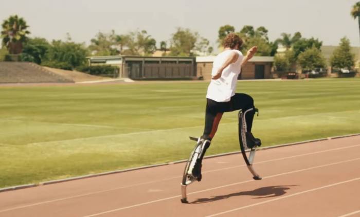 ben jacoby running on stilts on a track