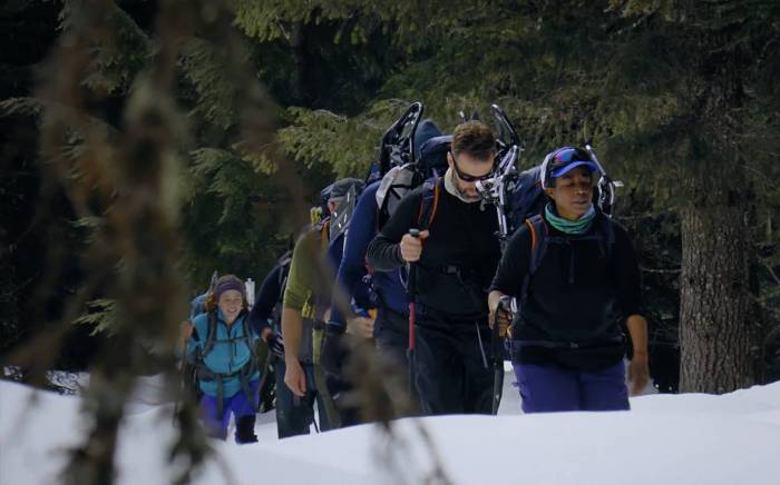 four people climbing up through snow on Mt. Hood