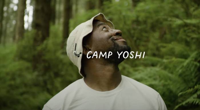 rashad in a beige bucket hat looking up and to the right