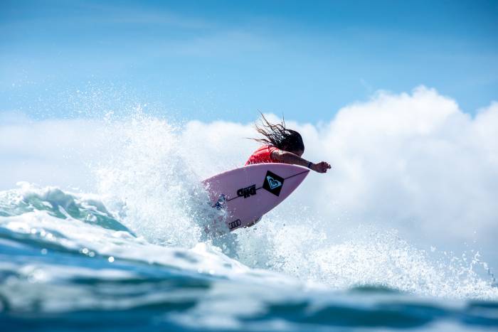 Stephanie Gilmore surfing and leaning away from board