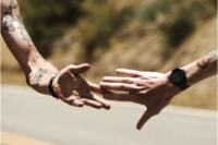 'Out on a Wire' Grunge Documentary Follows Unsanctioned, Underground 300-Mile Foot Race two runners reaching for each other's hands