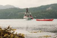 Witness Gulf of Alaska Whitewater in Boat-Camp-Surf 'Flowstate' Episode man fishing from boat with red kayak in foreground