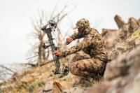 Straight Shooter: Brett Seng's 6 Tips for a Better Bowhunting Season person in sitka camo on a mountain drawing back a hunting bow and taking aim
