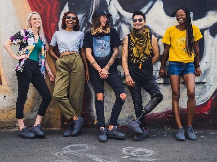 alex johnson and 4 other LGBTQ+ community members pose against a mural in the Evolv Pride Rebel street/approach shoes