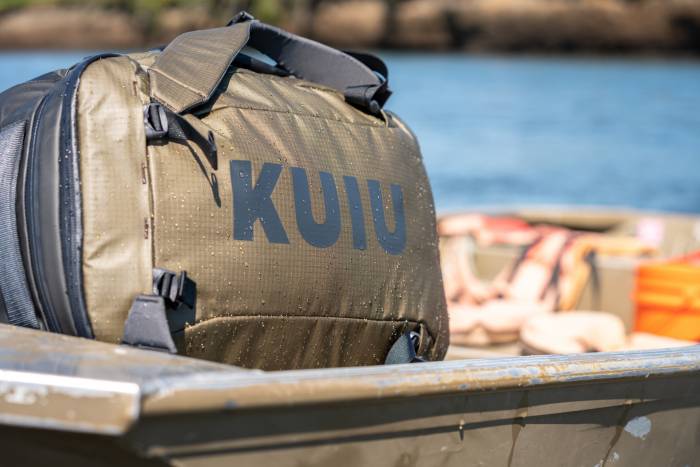 closeup of giant KUIU Waypoint duffel sitting on deck of boat