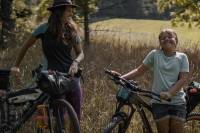 mother daughter duo Emily and Willow Zebel straddling their bikes and smiling