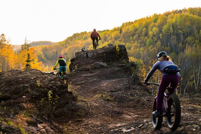3 people mountain biking in new park in Chisolm, Minn.