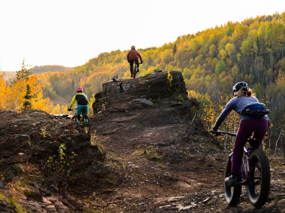 'Reclaimed' Uncovers Next Oasis of Mountain Biking in Minnesota 3 people mountain biking in new park in Chisolm, Minn.