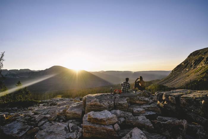 hikers overlooking mountains backcountry feature image sale article