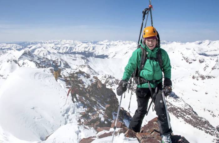skier christy mahon at the top of a 13,000 foot peak
