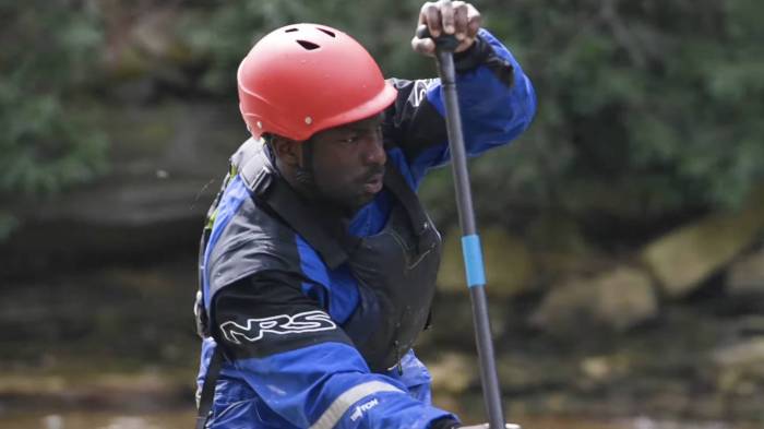 whitewater SUP paddler in red helmet tito onyekweli