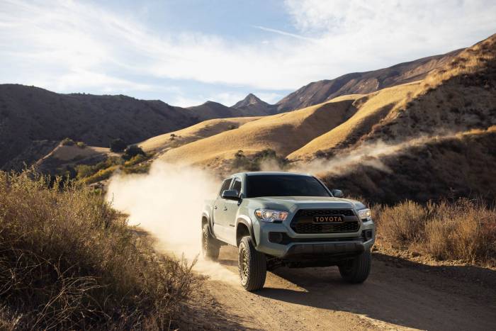front view of 2023 Toyota Tacoma driving on gravel road