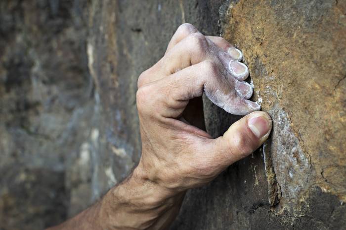 hand gripping rock climbing
