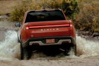 Rivian Recalls 502 Trucks, Citing Airbag Risk to Children Rivian fording water