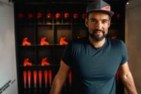 Benji Alexander in a baselayer and cap standing in an Atomic Ski studio