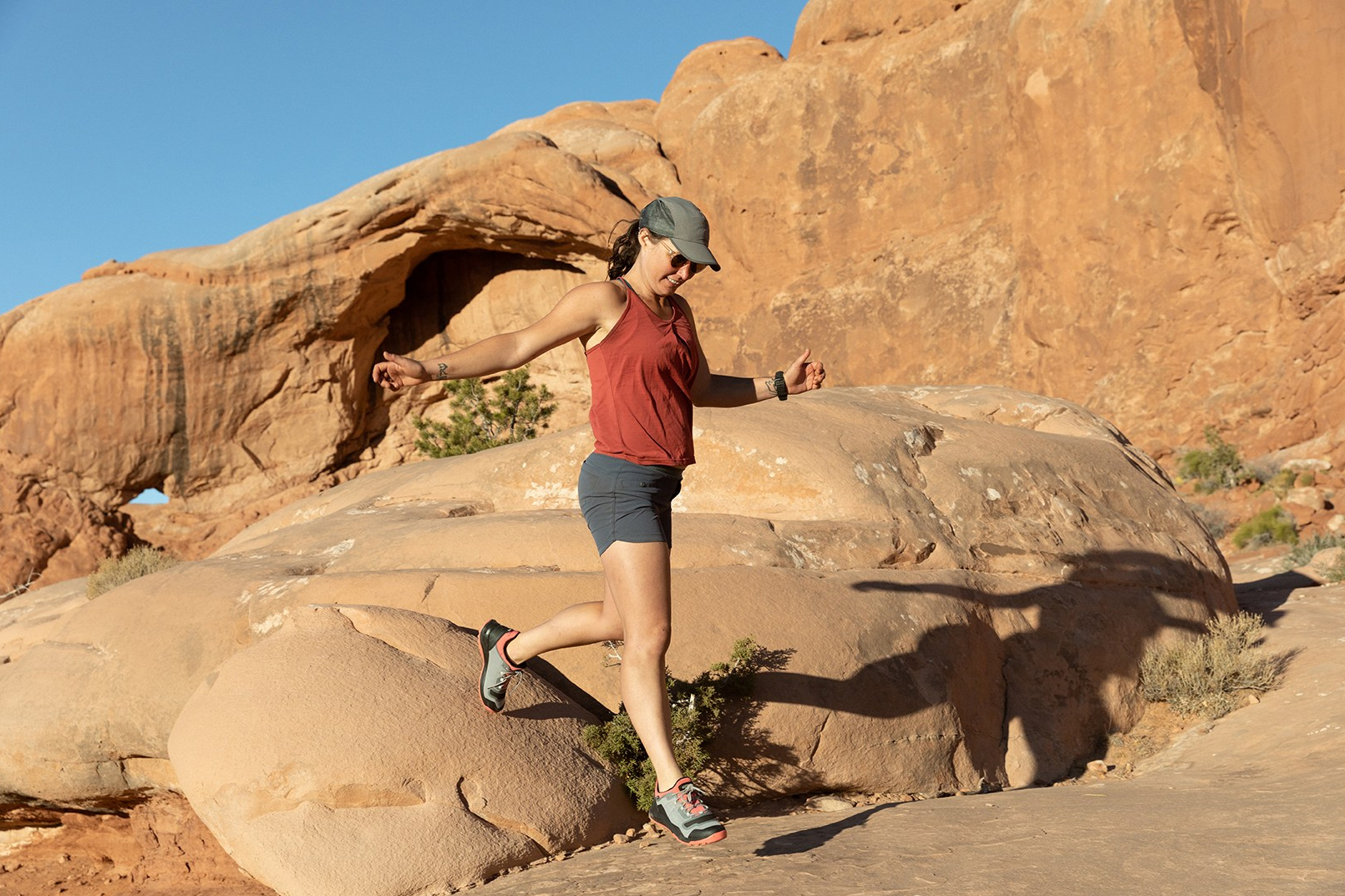 woman jumping while wearing hiking boots woman jumping while wearing hiking boots