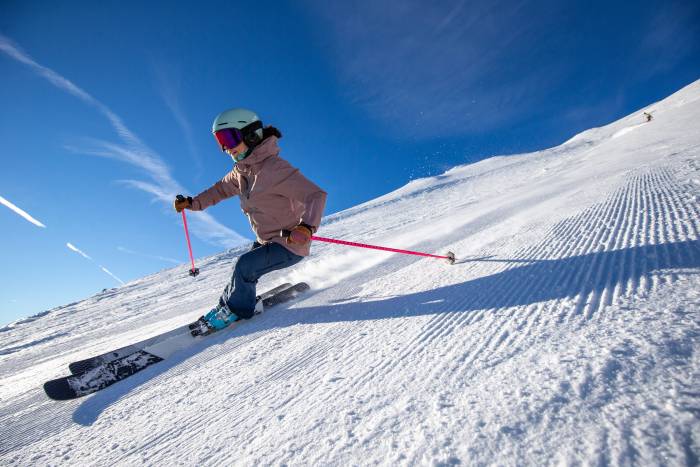 a skier on a groomed run with corn snow at Mt Bachelor