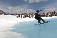 Ski Resort Pond Skims: Where and When to Skim in 2022 snowboarder pond skimming at whistler mountain