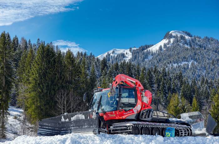 a red snowcat on a clear day