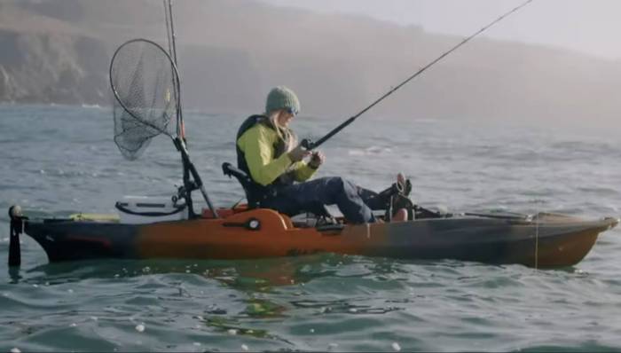 annie nagel kayak fishing on a freshwater lake