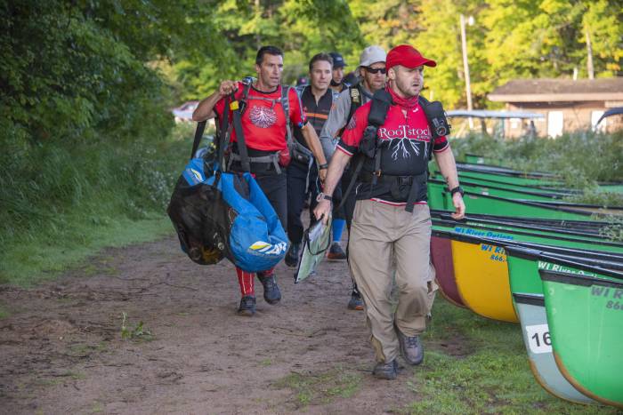 A team arriving to their canoes for the paddling portion of their Adventure Race at USARA Nationals in 2021.