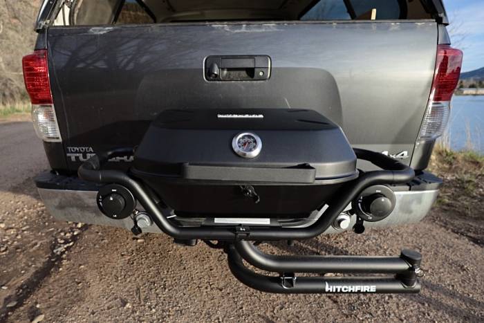 The HitFire F-20 Grill folded up in its mounting position on the outside of a pickup truck's hitch rack