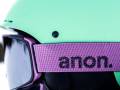 2023 Anon M4.S Goggle Review: Securely Snap Into a Dozen Stellar Lens Options a close up view of the women's Anon ski goggles with a purple strap against a teal helmet