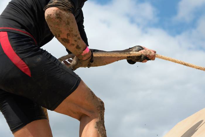 a man climbs up a rope