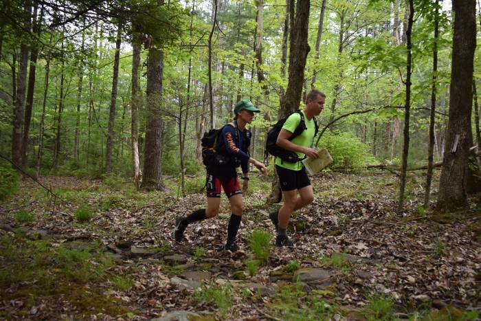 two adventure racers running through the woods during a USARA adventure race in New York
