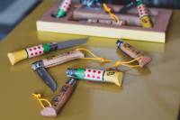 Opinel Celebrates the Tour de France With Limited-Edition 'Yellow Jersey' Knives Opinel No. 08 knives arranged on a desk.
