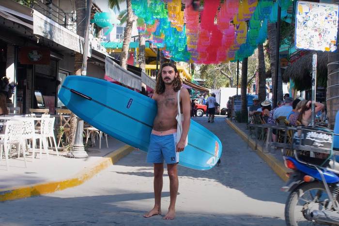 Andy Nieblas and his surfboard in Sayulita Mexico