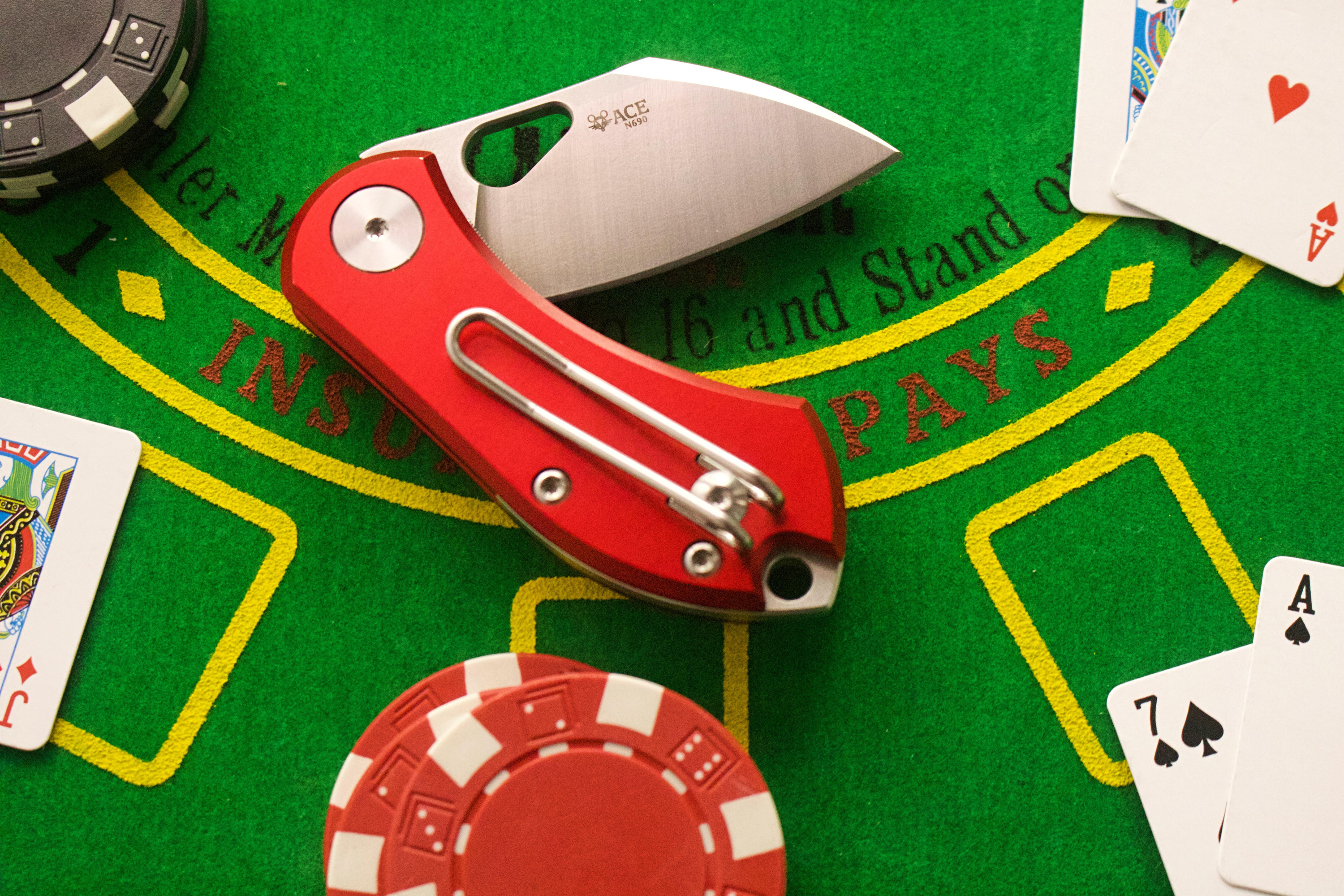 giant mouse ace nibbler folding knife on poker table