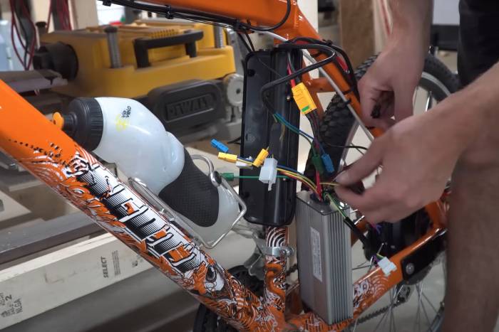 a close-up shot of a man converting his bike to an ebike