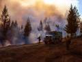 US Forest Service to Offer Paid Wildland Firefighter Training for Women a forest fire being attended by a fire crew