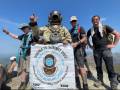 'Diver Man' Climbs Mountain in 180-Lb. Vintage Diving Suit, Raises Money for Little Girl subsea to summit