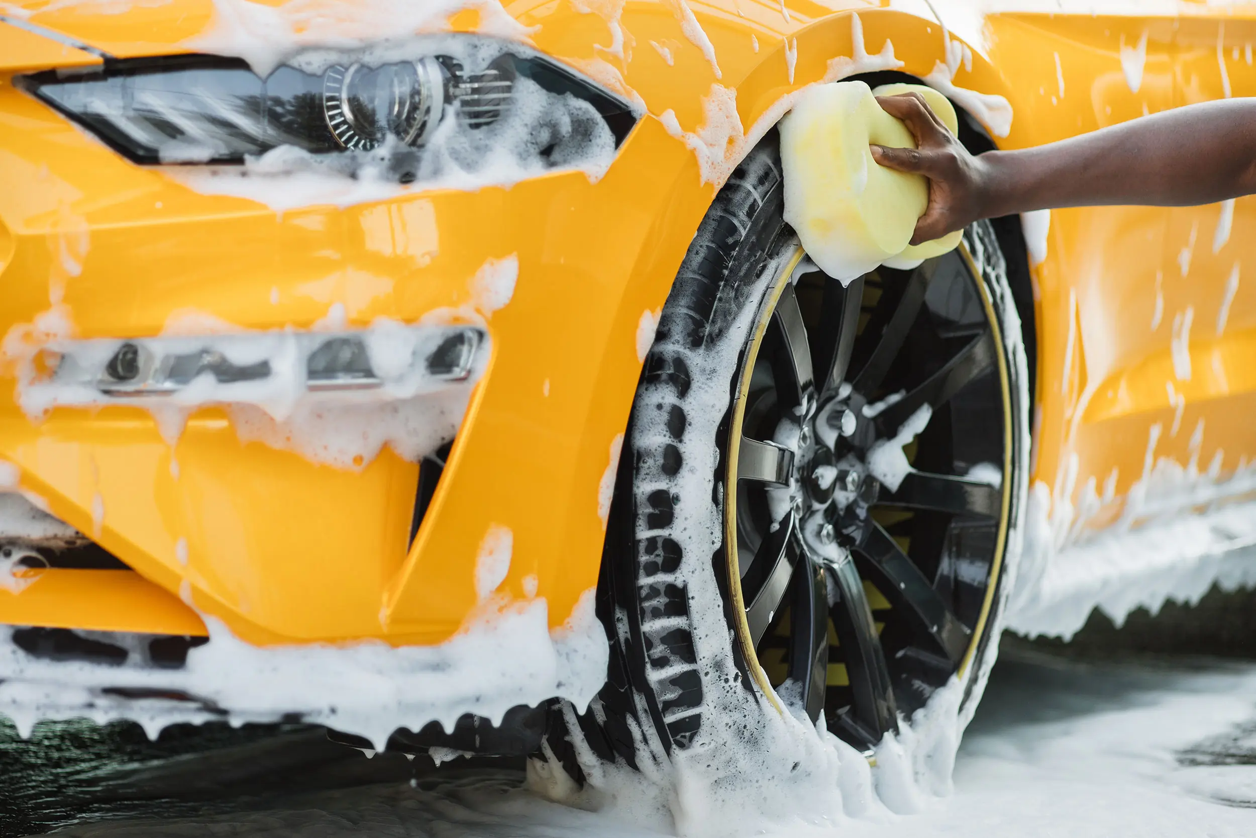 hand washing yellow car
