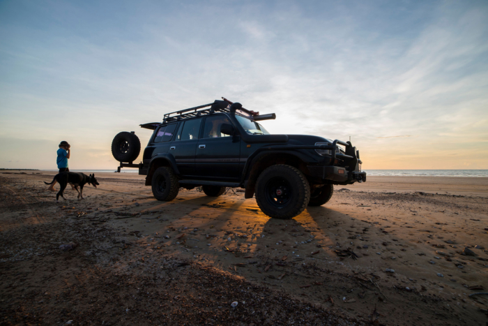 sunset behind toyota land cruiser 80 series on beach