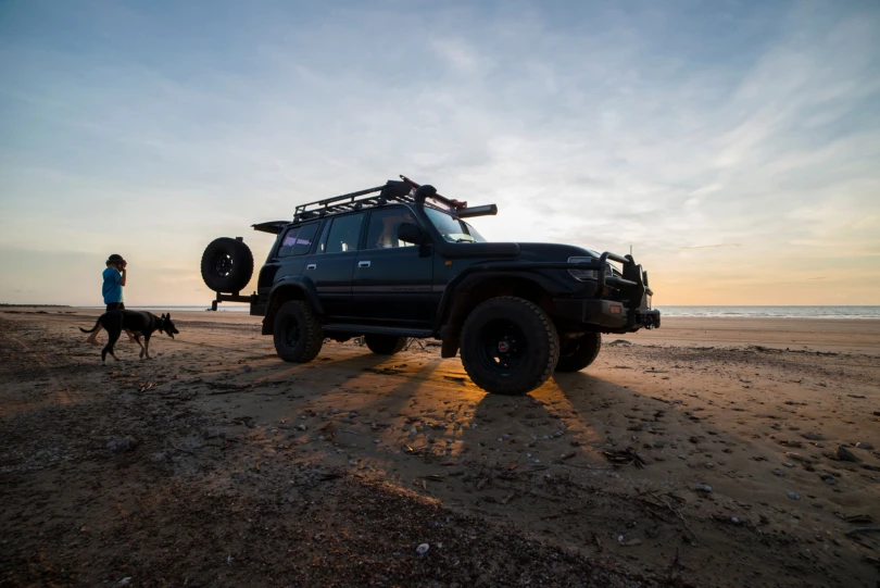 sunset behind toyota land cruiser 80 series on beach