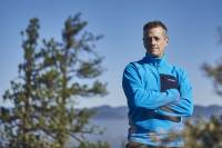 'Chillest Humans': Meet America's Toughest Race Director Race director and adventure racing pro Jason Magness stands on top of a mountain with clouds and trees in the background.