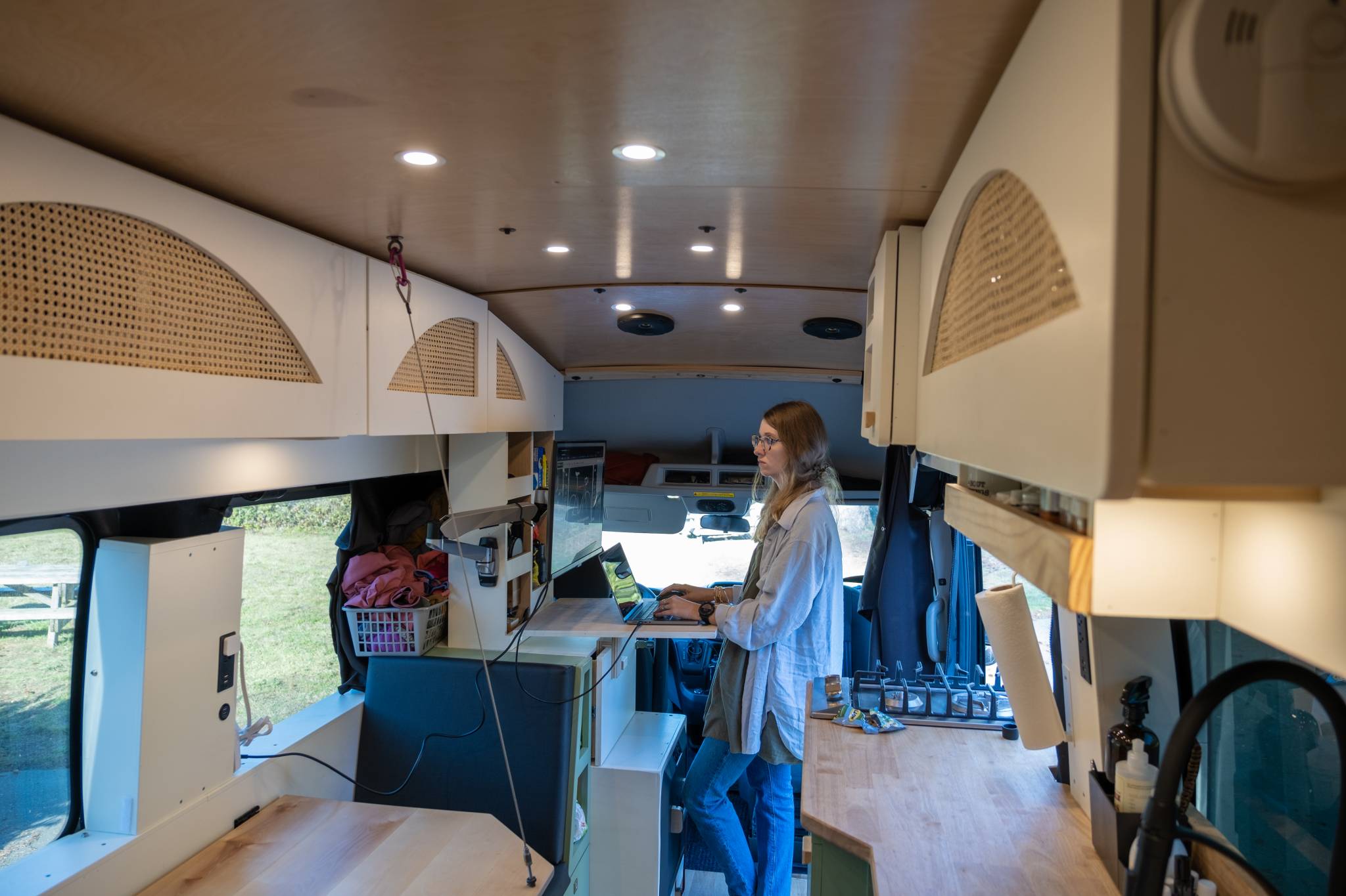 Mom working remotely from the road in converted campervan vanlife Mom working remotely from the road in converted campervan vanlife