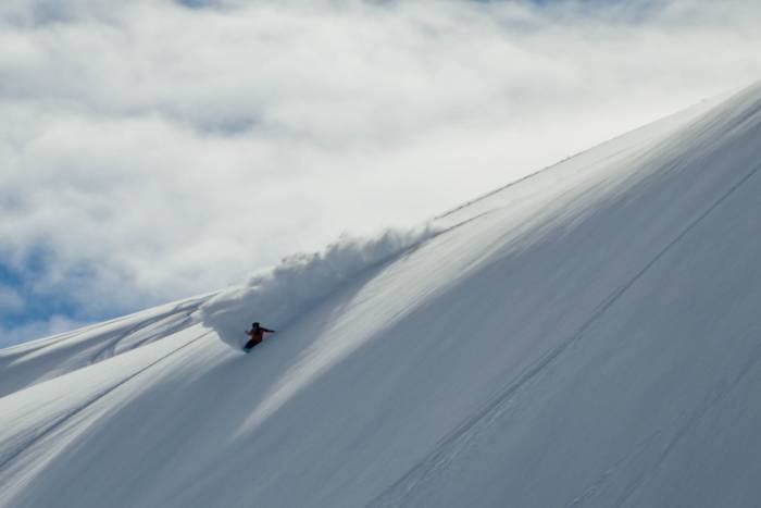 Curtis Ciszek snowboarding in some fresh powder