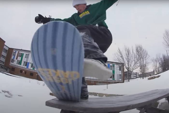 a rider does a trick on an ambition snowskate