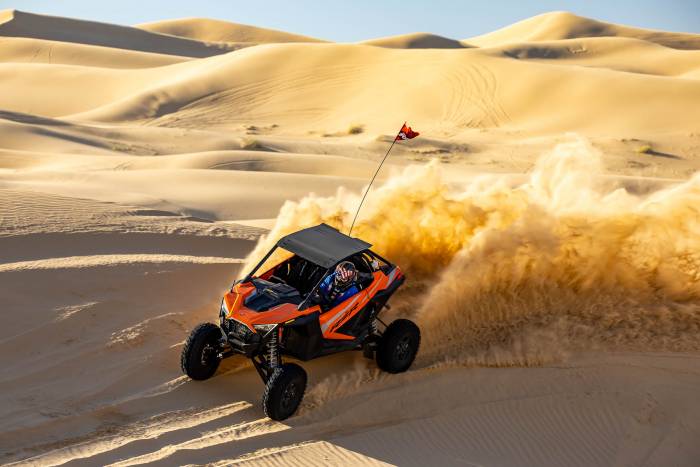 2023 Polaris RZR Turbo R driving on a sand dune