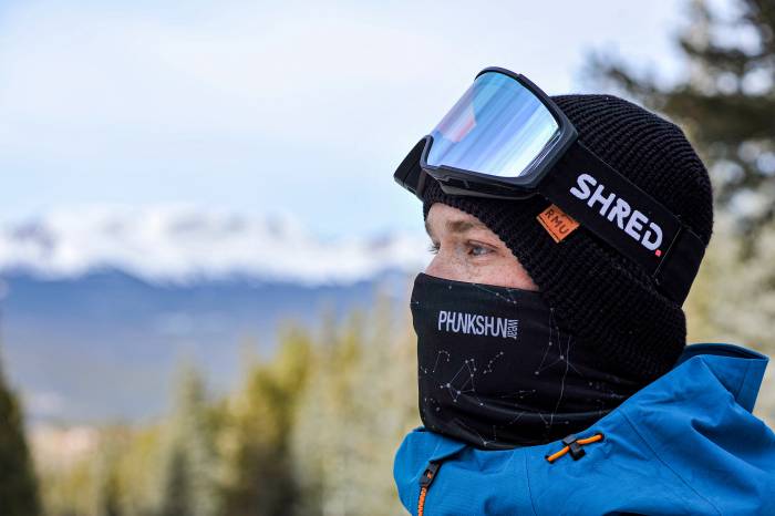person wearing ski goggles, hat and a Phunkshun neck gaiter
